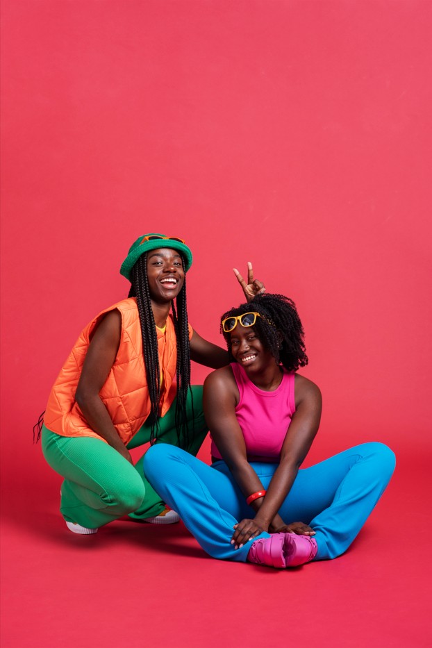 Two Nigerian students sitting together with a laptop, planning their accommodation